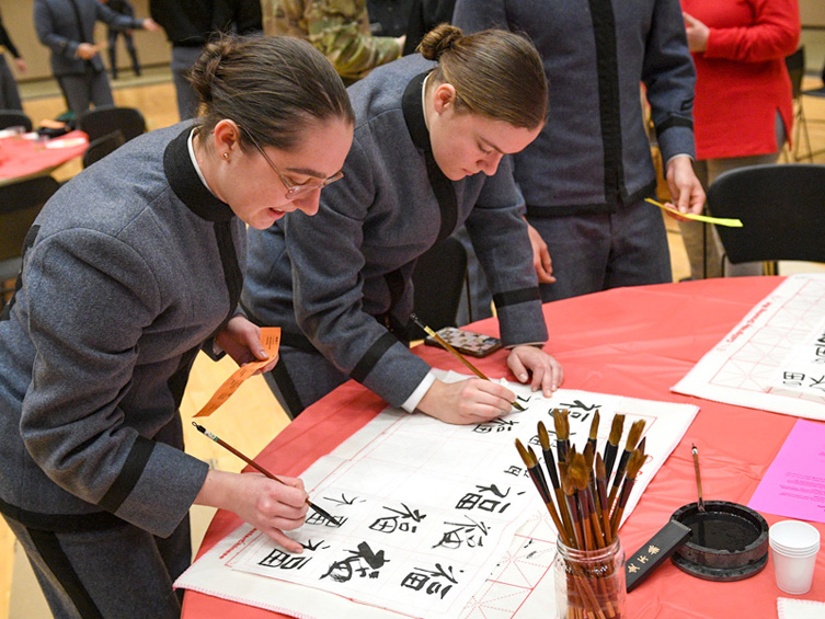 ֻ̳cadets writing Chinese calligraphy during Lunar New Year event