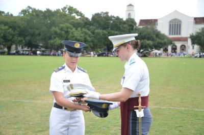 Kasey Meredith ’22 and Kathryn Christmas, Citadel regimental commander, exchange momento covers at the Citadel.—ֻ̳Photo by Eric Moore.