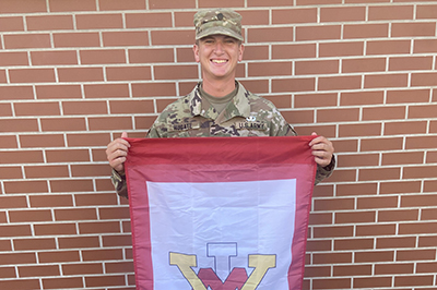 Cadet Carter Hugate '24 holds ֻ̳flag at Army Airborne School