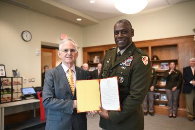 Maj. Gen. Cedric T. Wins ’85 presents Sen. Thomas K. Norment Jr. ’68 with a resolution from the Board of Visitors.