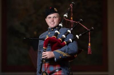 Dakota Birdsong ’24, a cadet at ֻ̳, poses with his bagpipe and ֻ̳Pipe Band uniform, which includes a tartan.